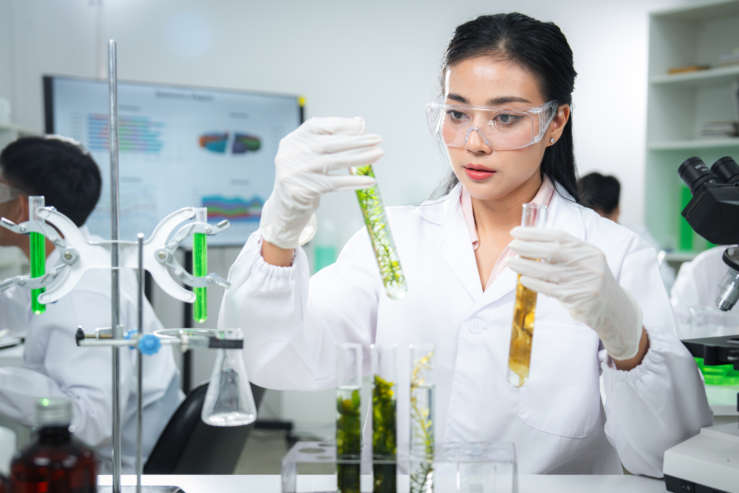 Scientist examining plant-based samples in a modern laboratory, representing sustainability, biotechnology, clean energy, and climate action concepts for ESG, green innovation, corporate communication