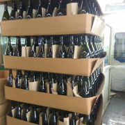 Beverage bottles packed in layer trays awaiting export shipment