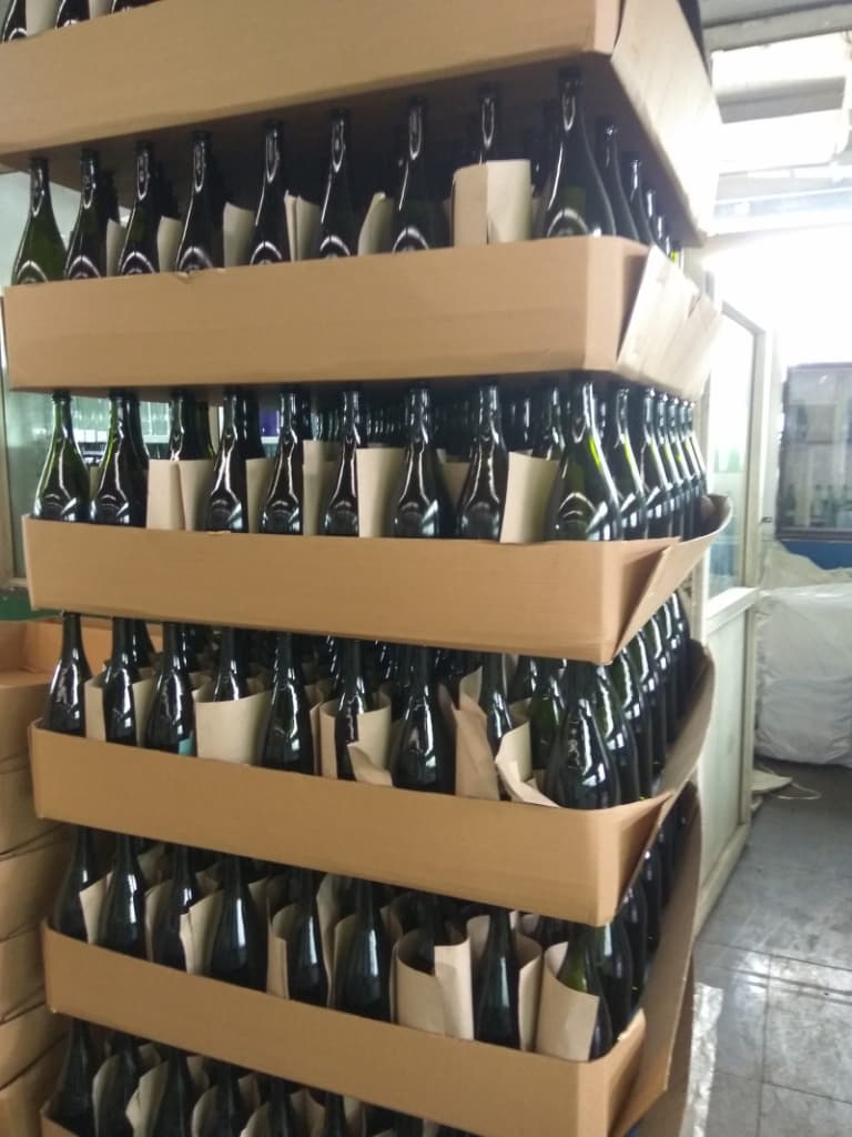 Beverage bottles packed in layer trays awaiting export shipment